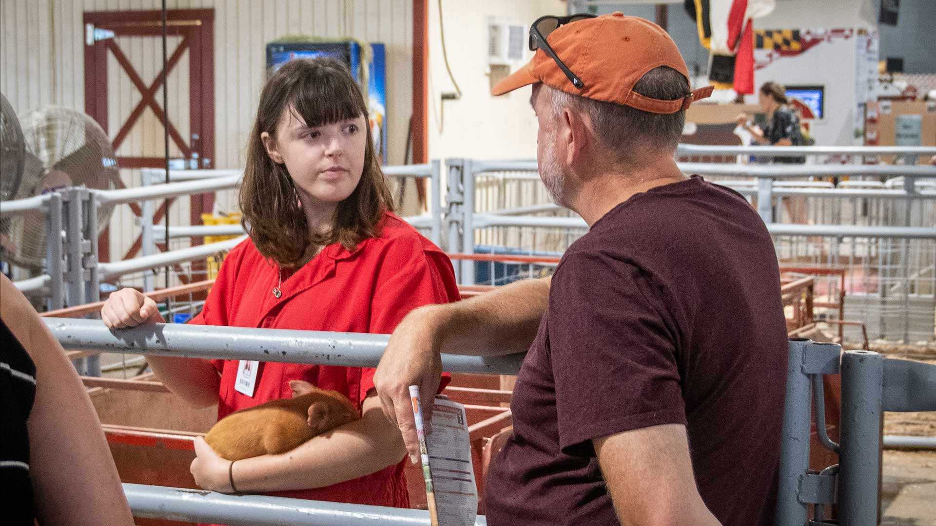 woman holds piglet
