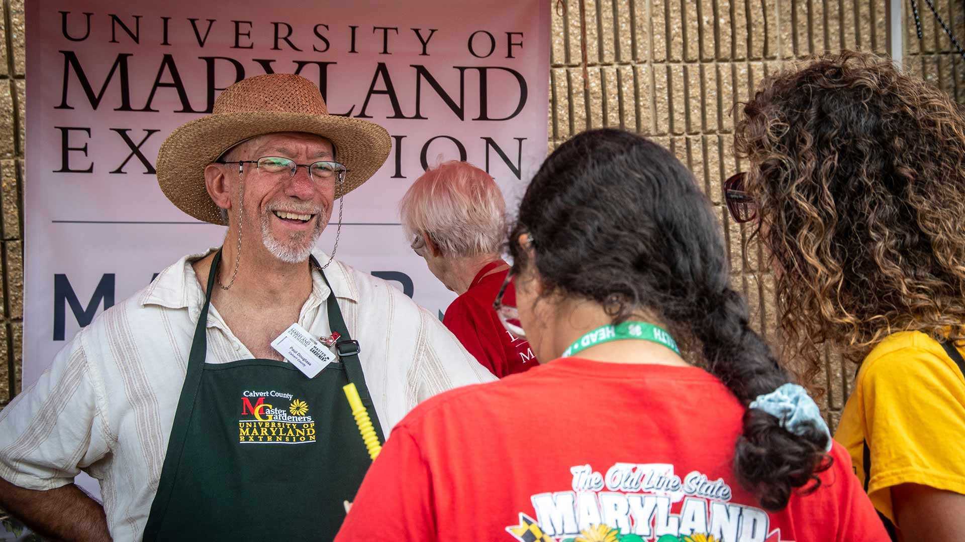 master gardener talks to people at fair