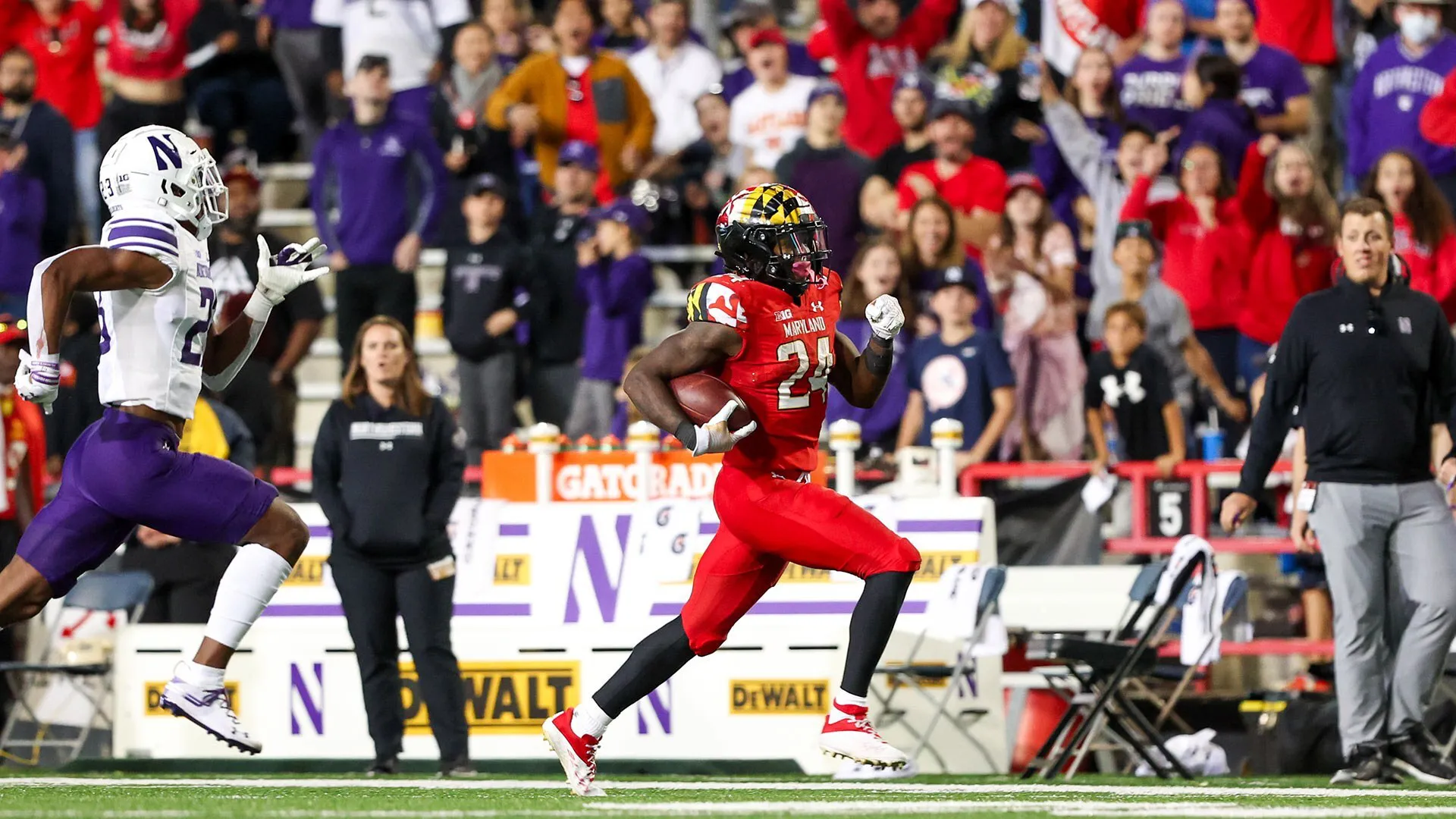 roman hemby rushes for a touchdown pursued by northwestern player