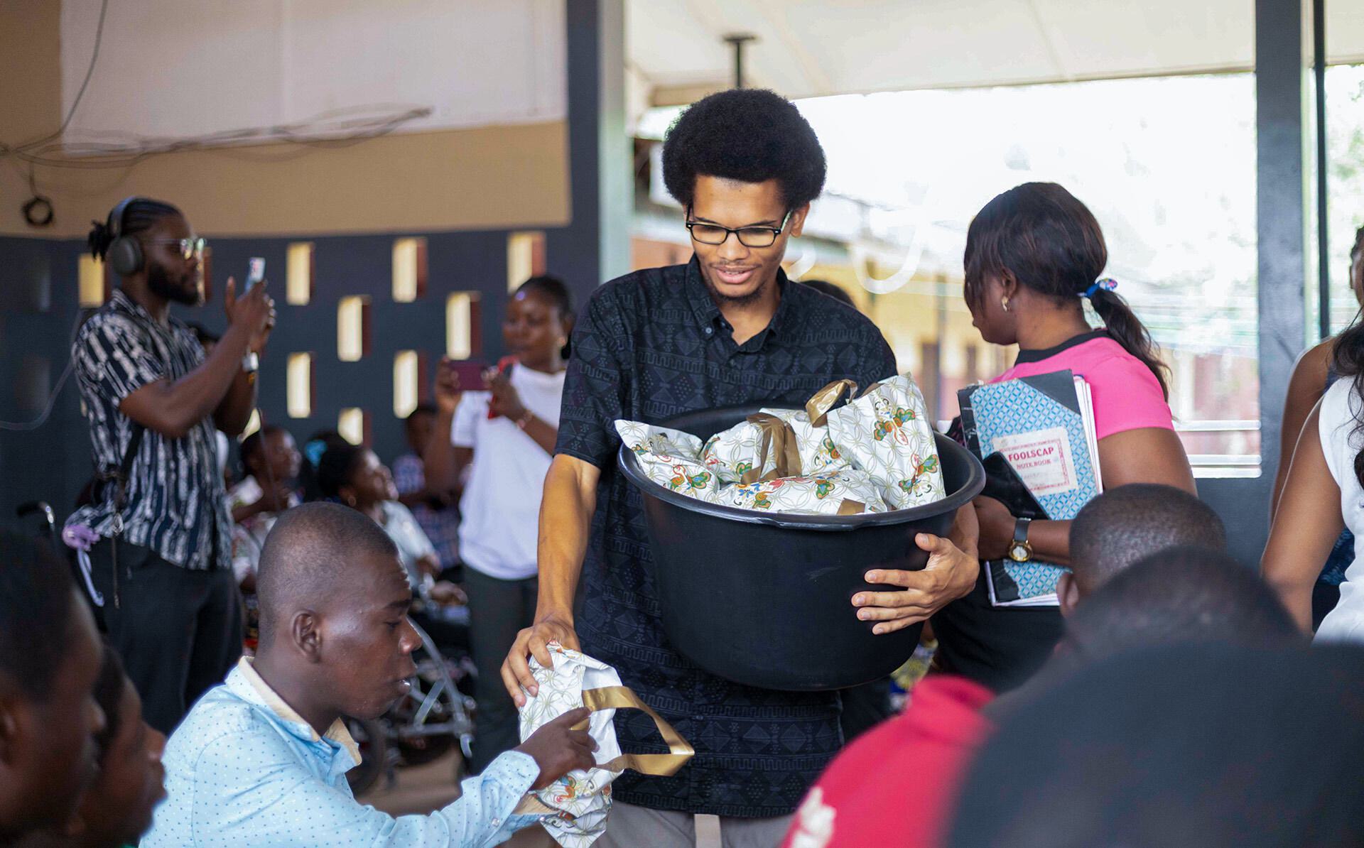 man hands out bags from black container