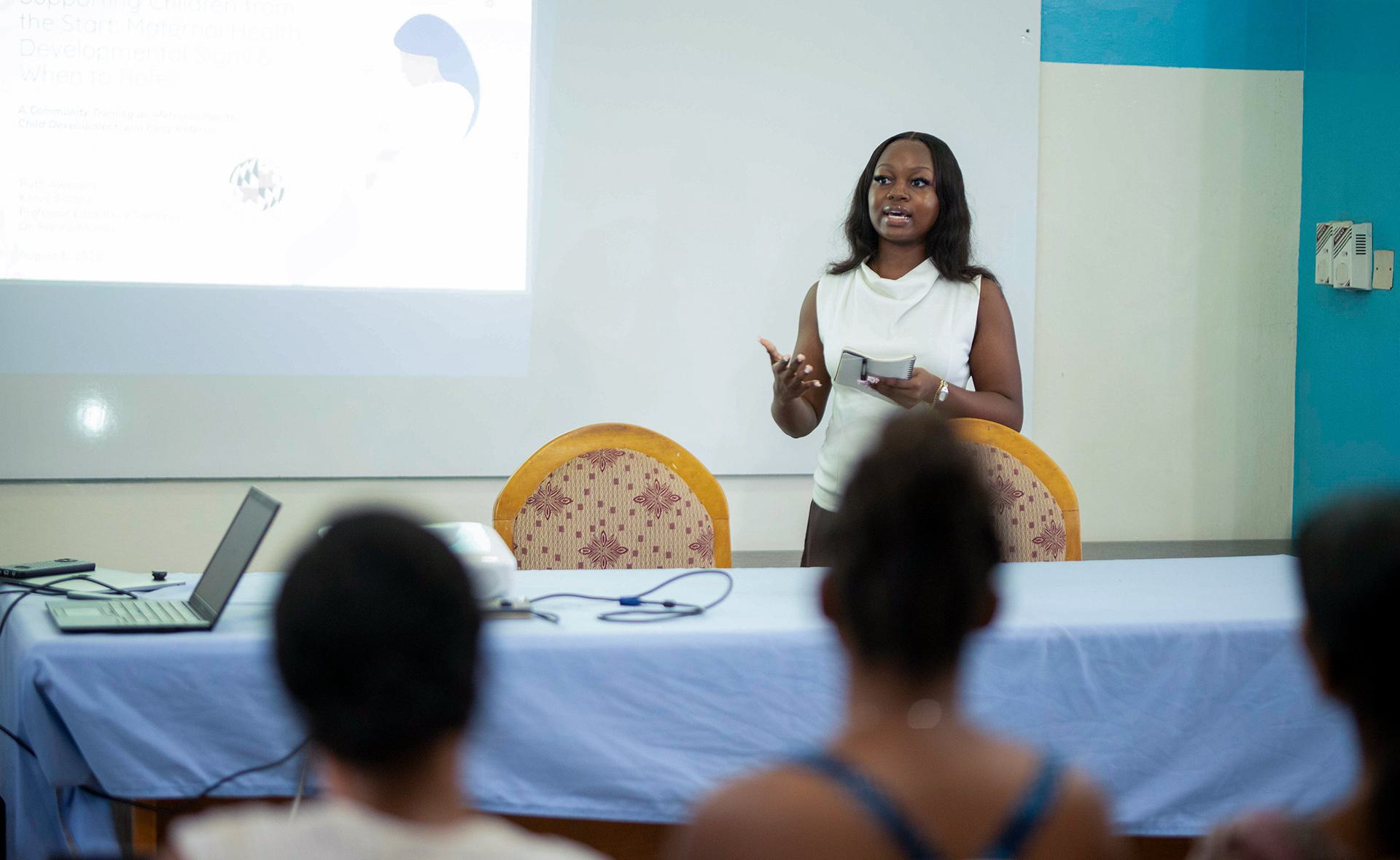 woman speaks at front of classroom