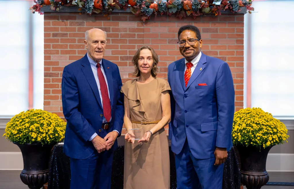 Cheryl L. Knott poses with award