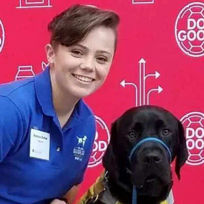 Vanessa Barker headshot with black Lab