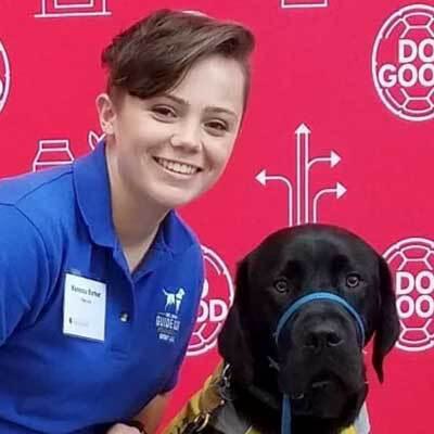 Vanessa Barker headshot with black Lab
