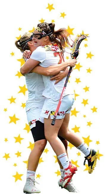 two women's lacrosse players hug