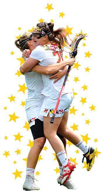 two women's lacrosse players hug