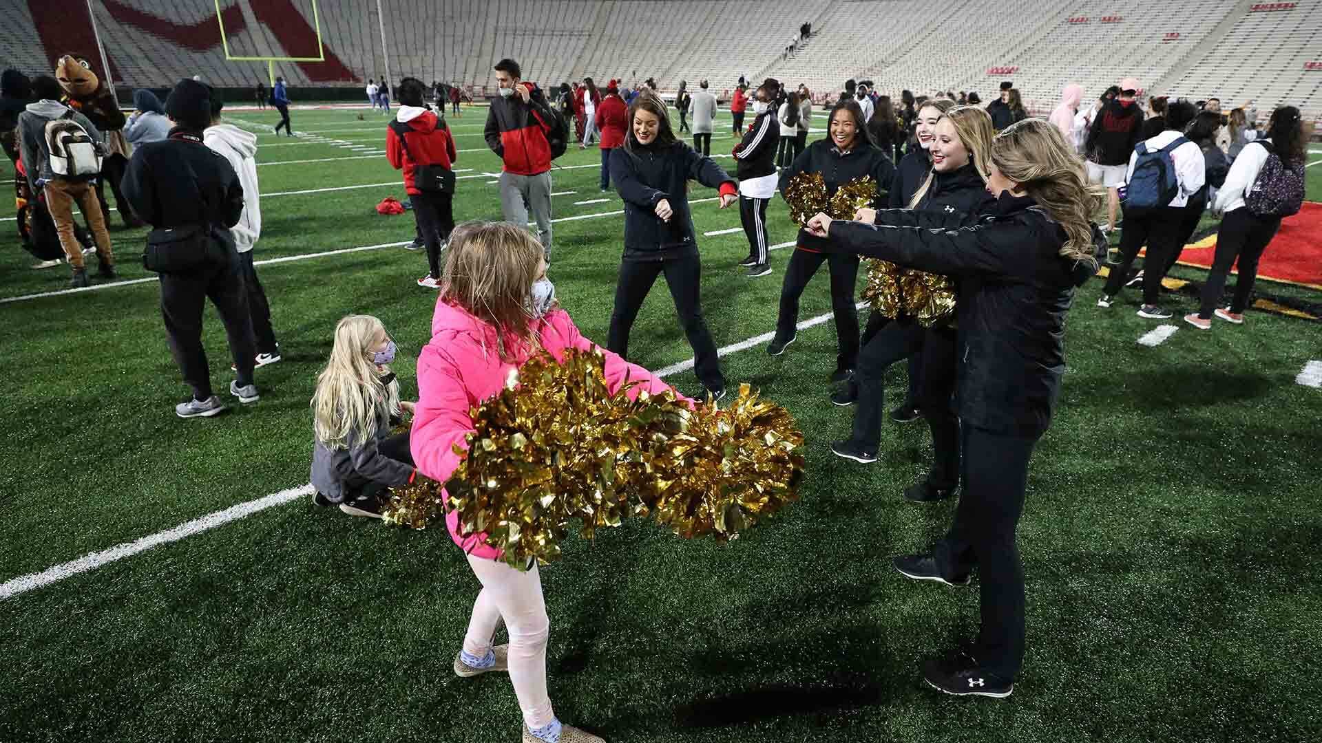 UMD cheerleaders demonstrate their moves to young fans at Tuesday Night Lights event at football stadium