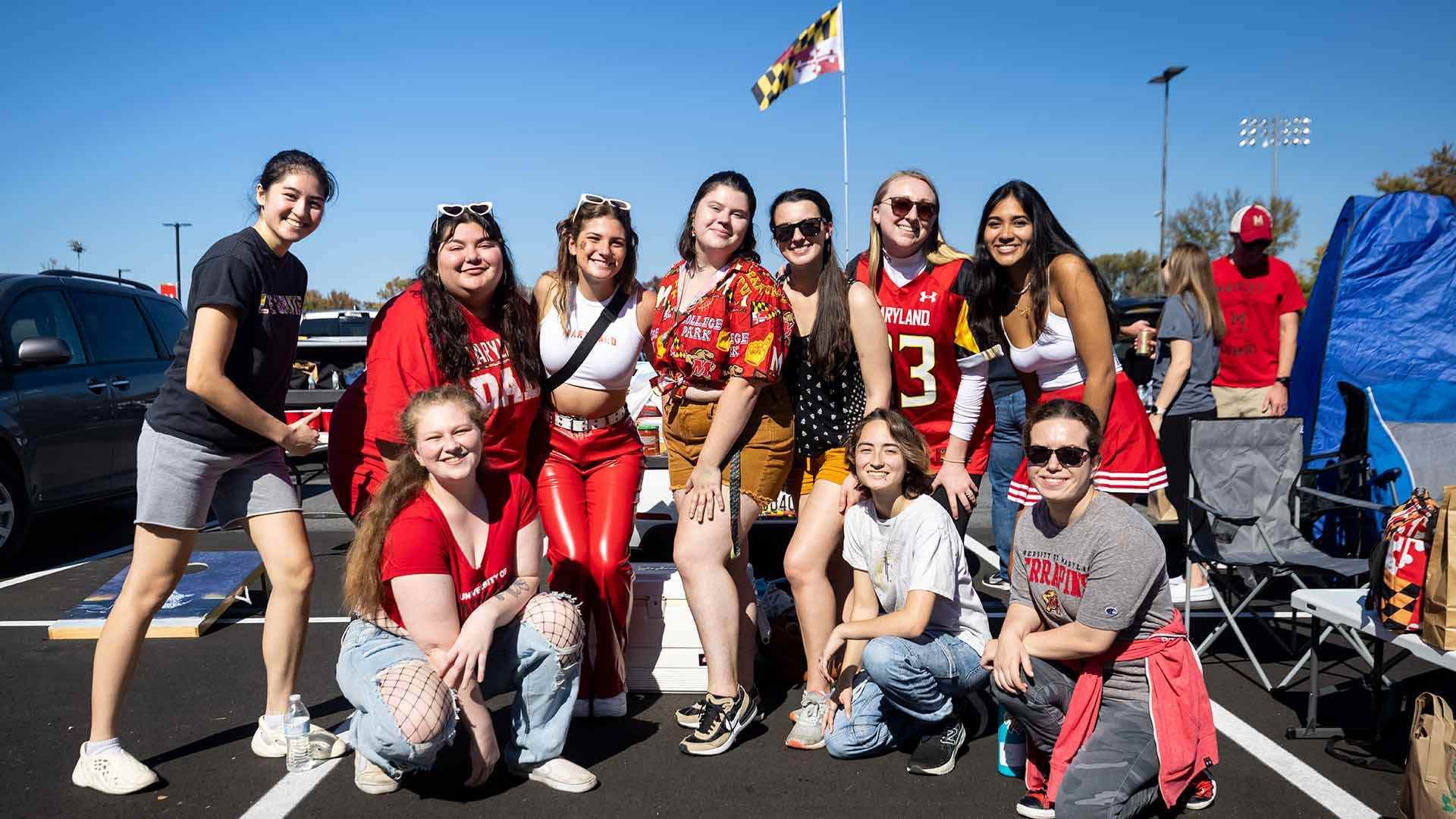 sorority members pose for photo at tailgate party