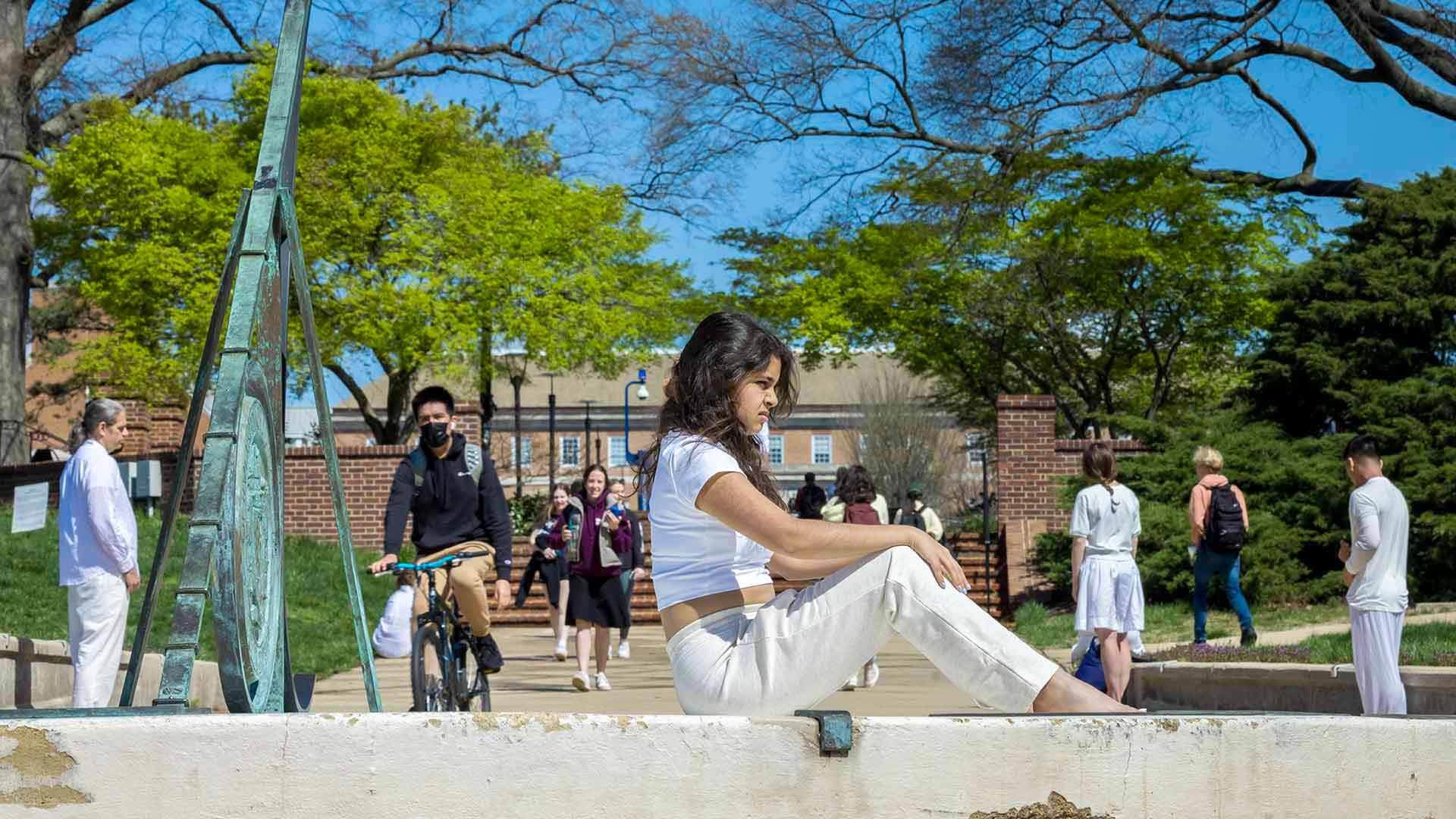 Student sits on sundial