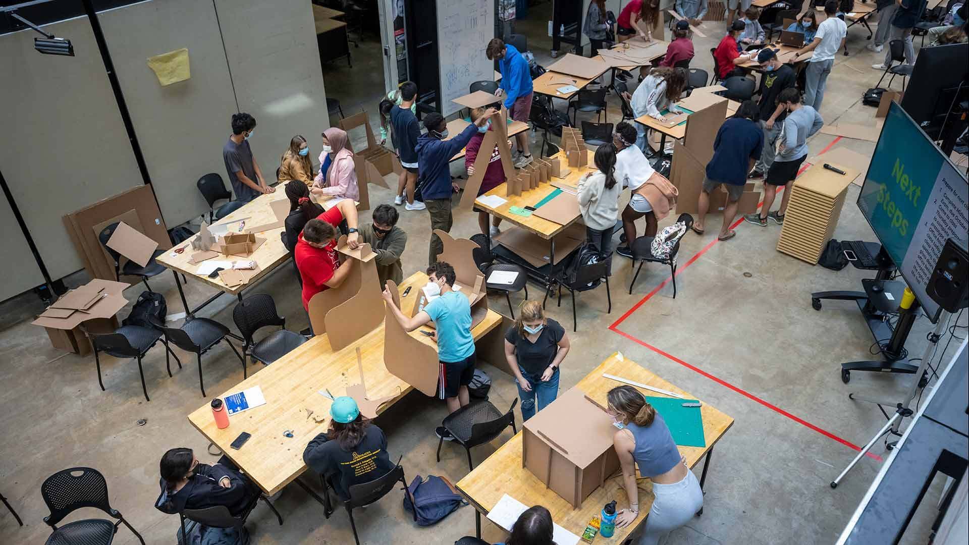 Students build cardboard chairs