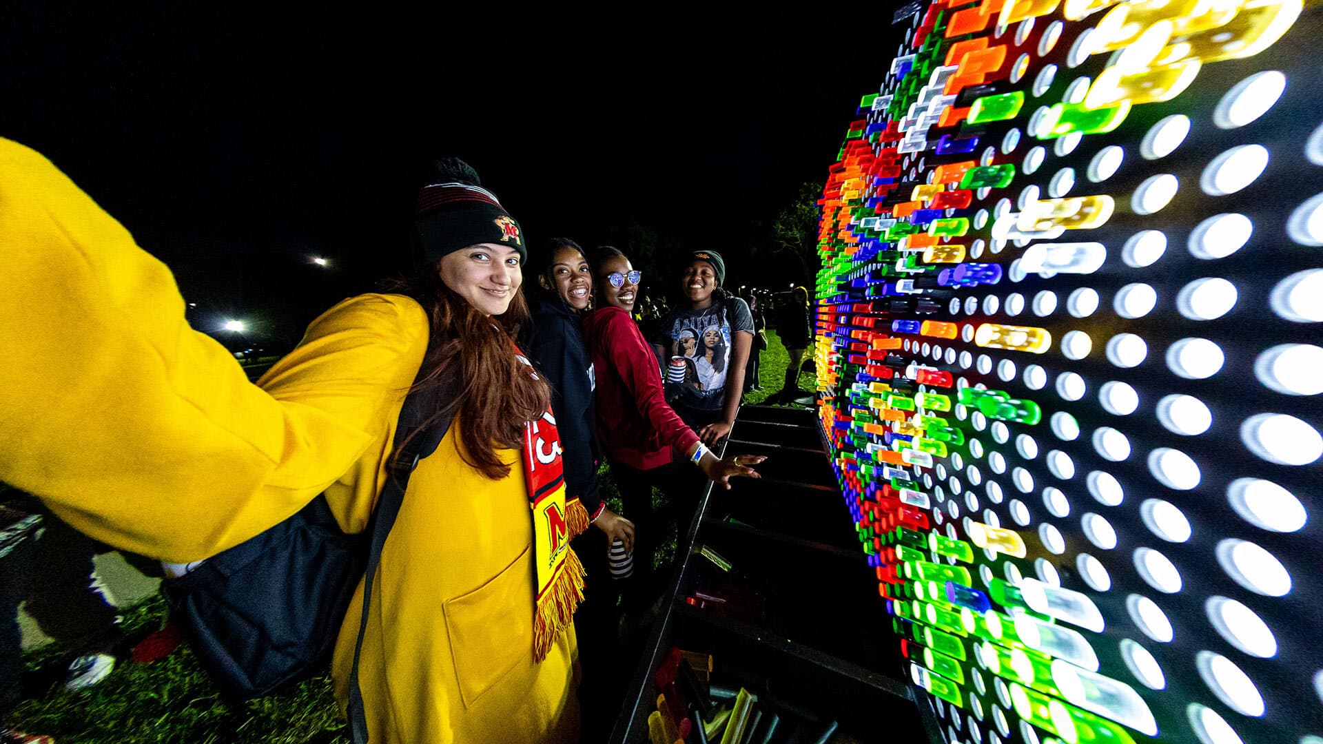 people play with a giant lite-brite toy