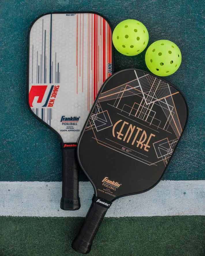Two pickleball paddles and balls