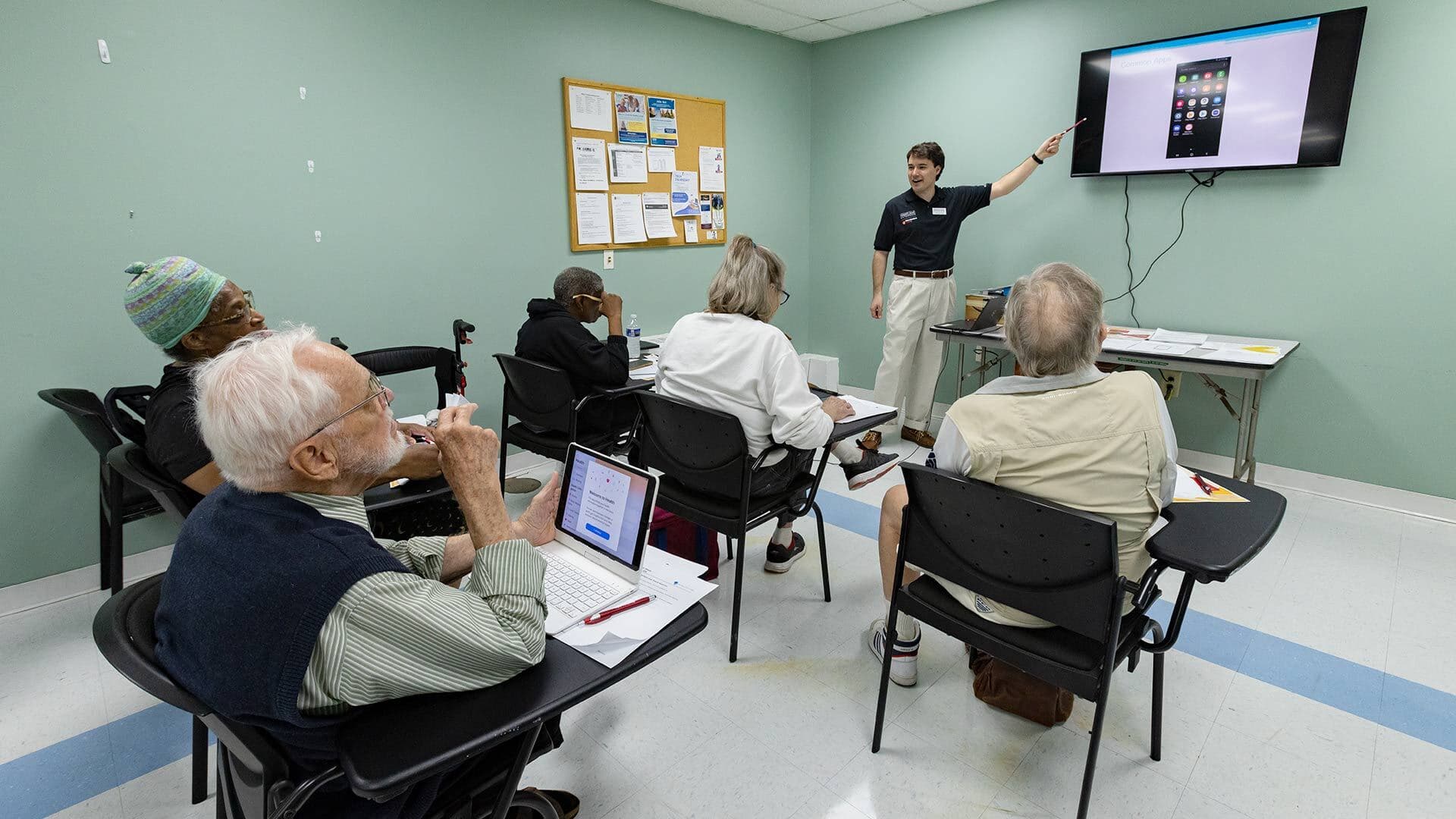 instructor presents about smartphones to senior students