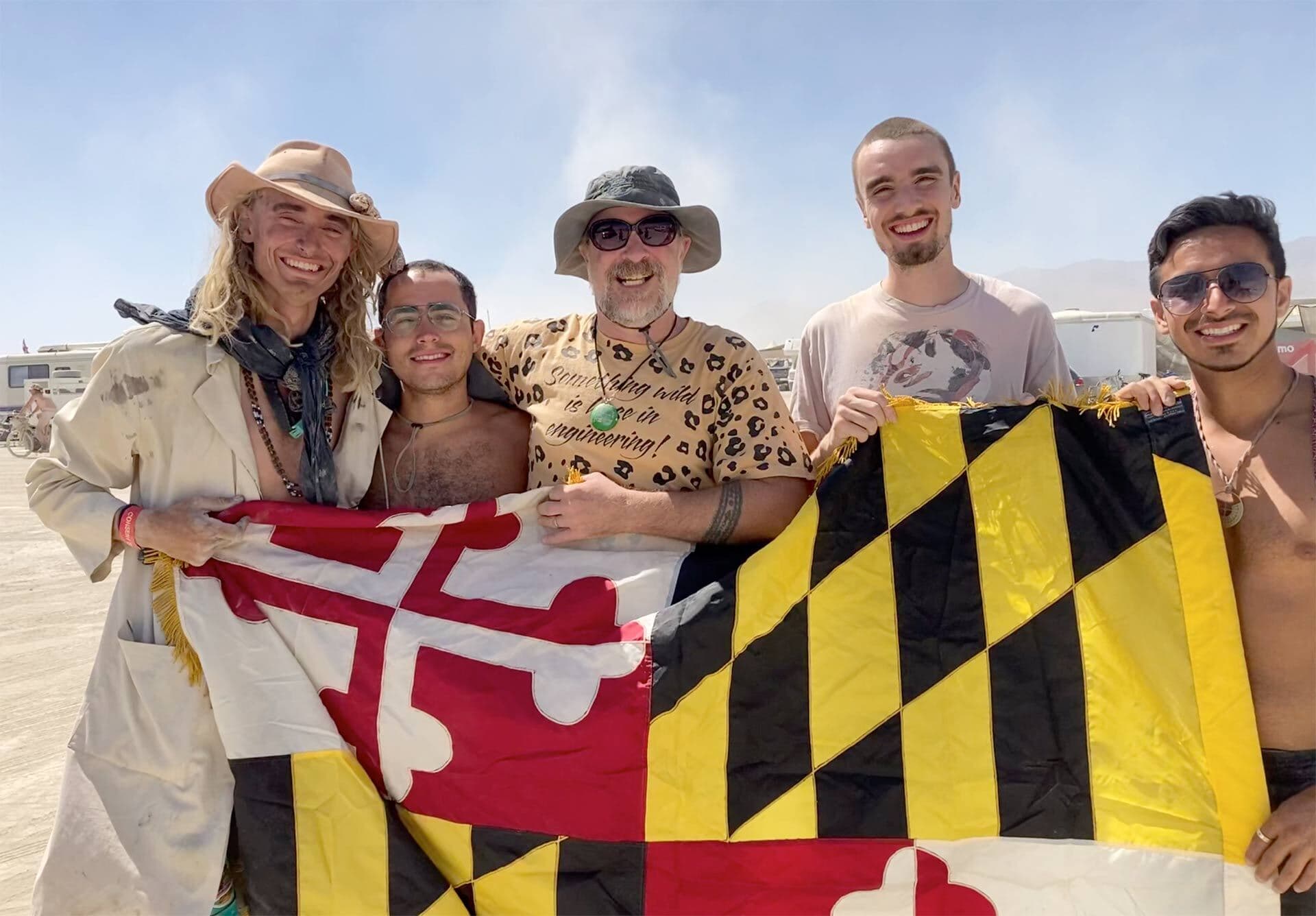 Group of five holds Maryland state flag at Burning Man