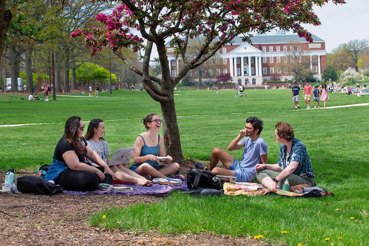 Group of students sits on blankets on McKeldin Mall