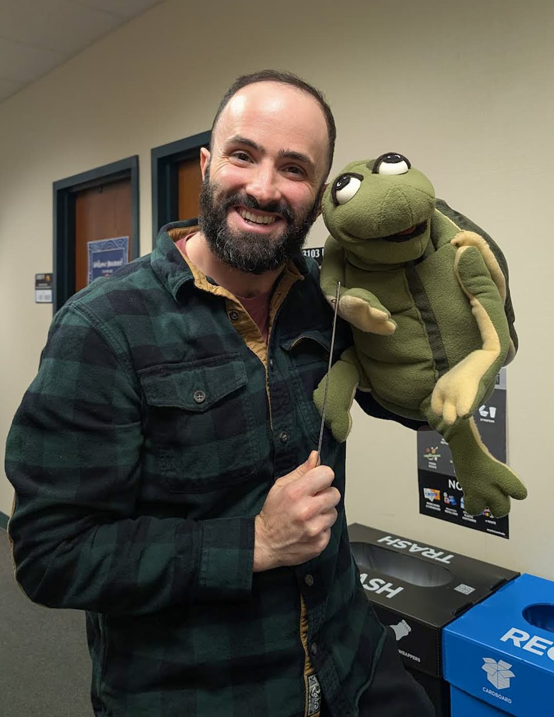 man holds turtle puppet