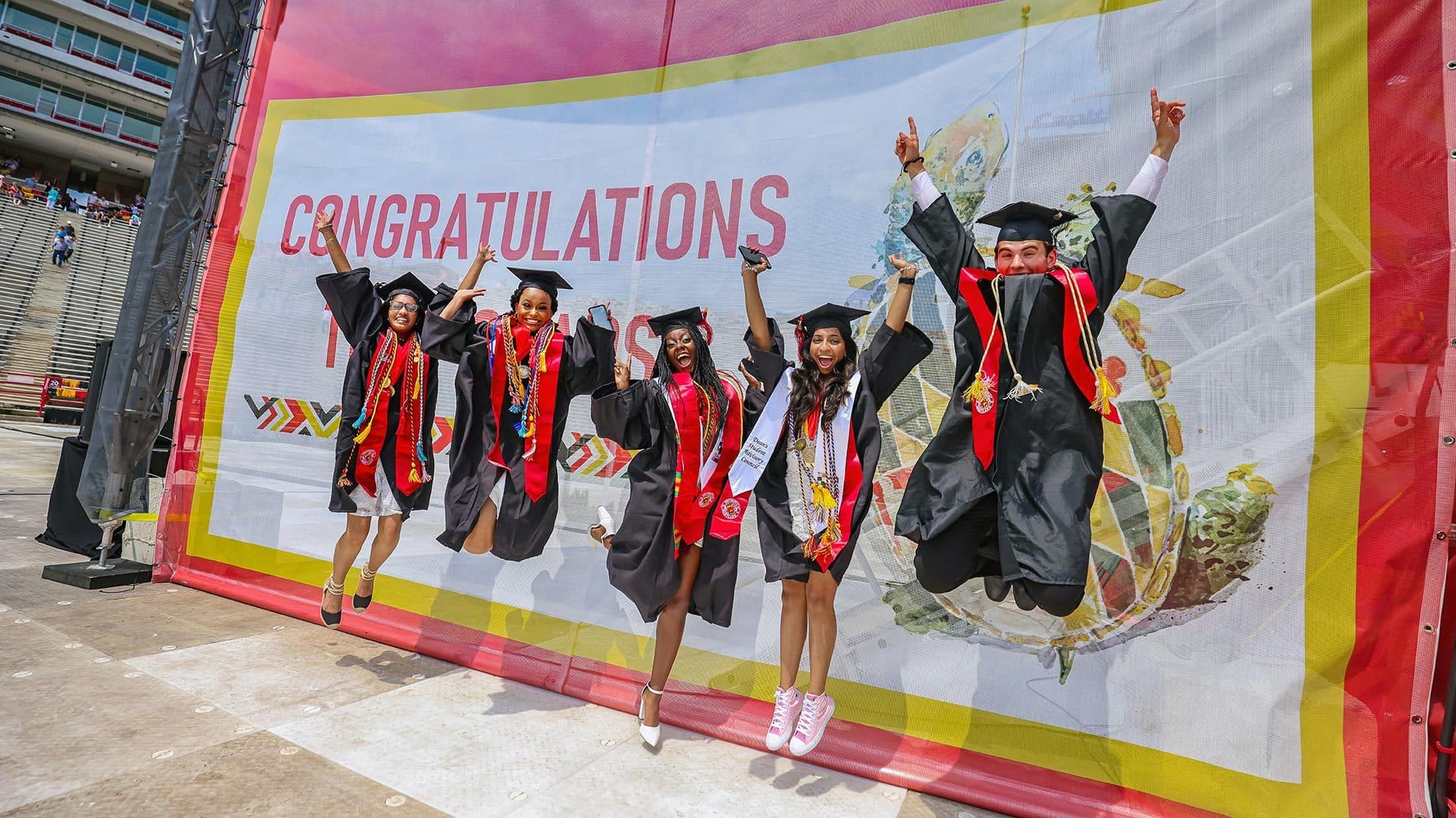 Graduates jump for photo
