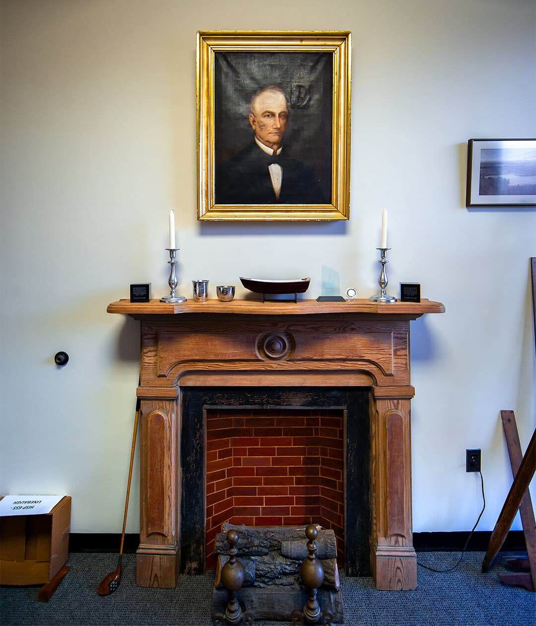 Mantel with portrait hanging above it