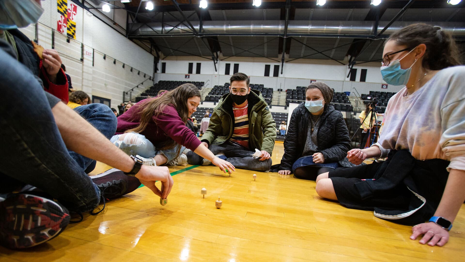 students spin dreidels at "Spin Love, Not Hate" event