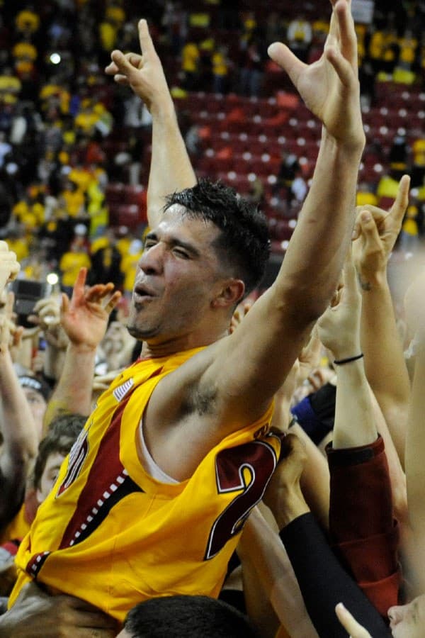 Male basketball player with both arms raised