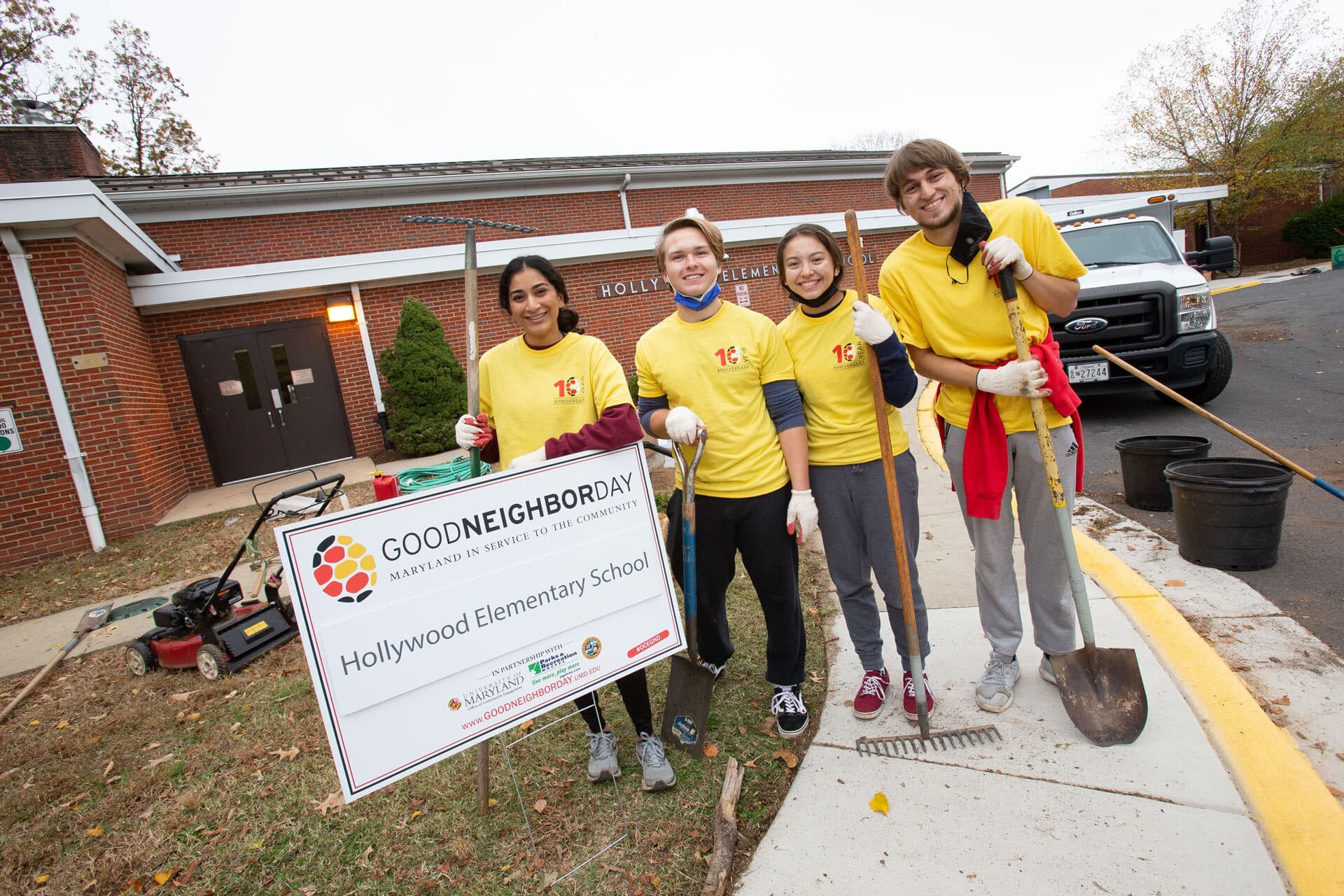 four student volunteers pose outside Hollywood Elementary