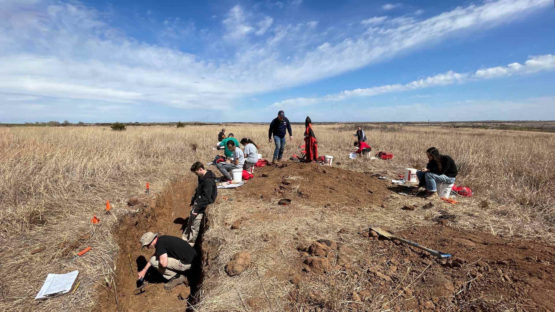 students test soil in pit