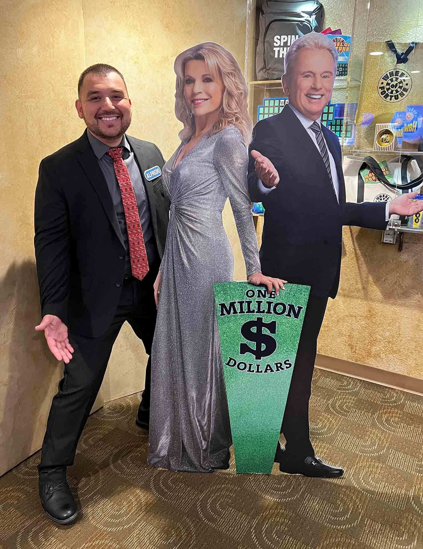 Alfredo Oliveira with cut-outs of Vanna White and Pat Sajak