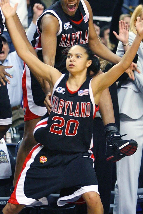 Female basketball player with both arms up