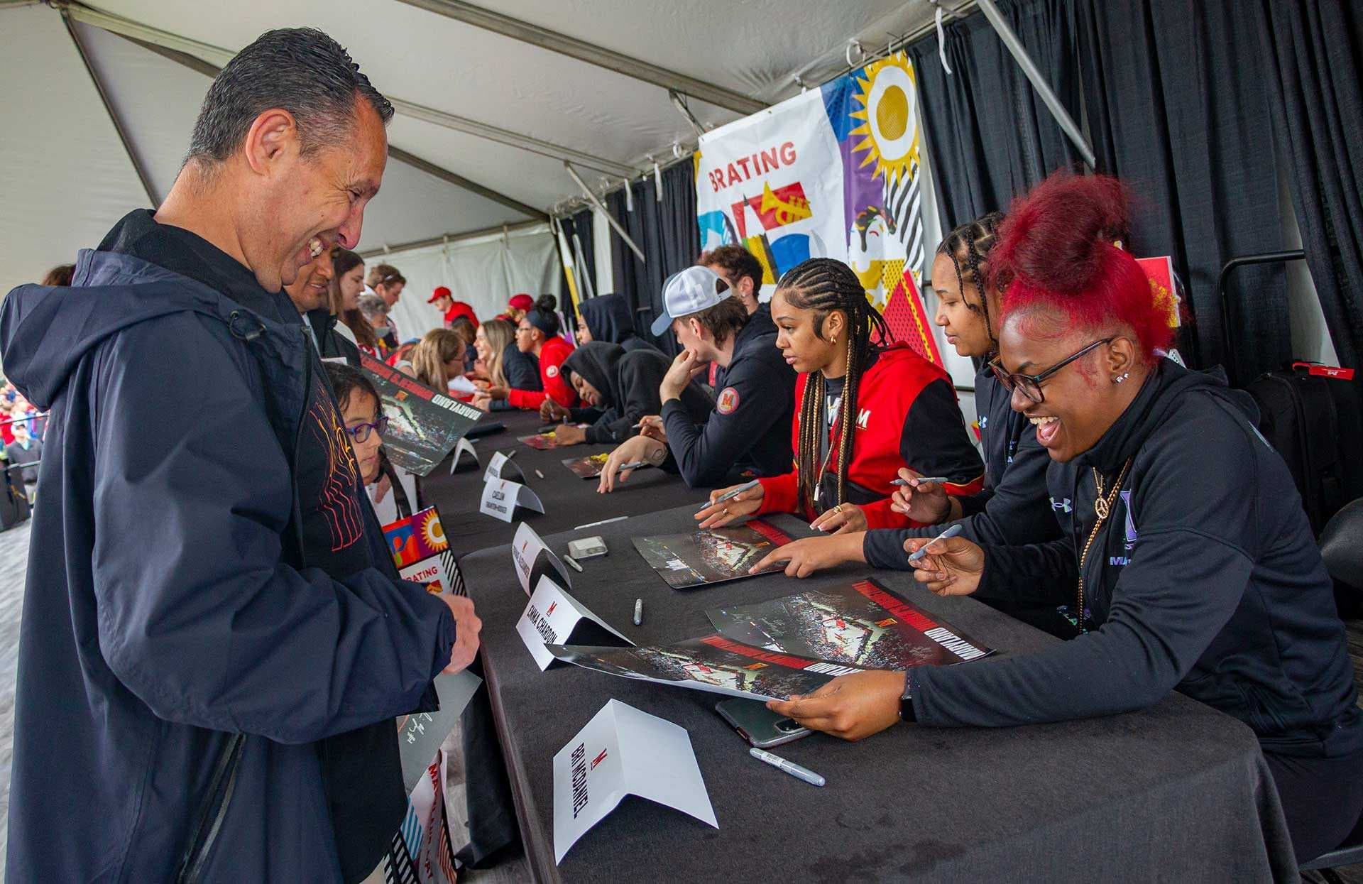 athletes sign autographs for fans