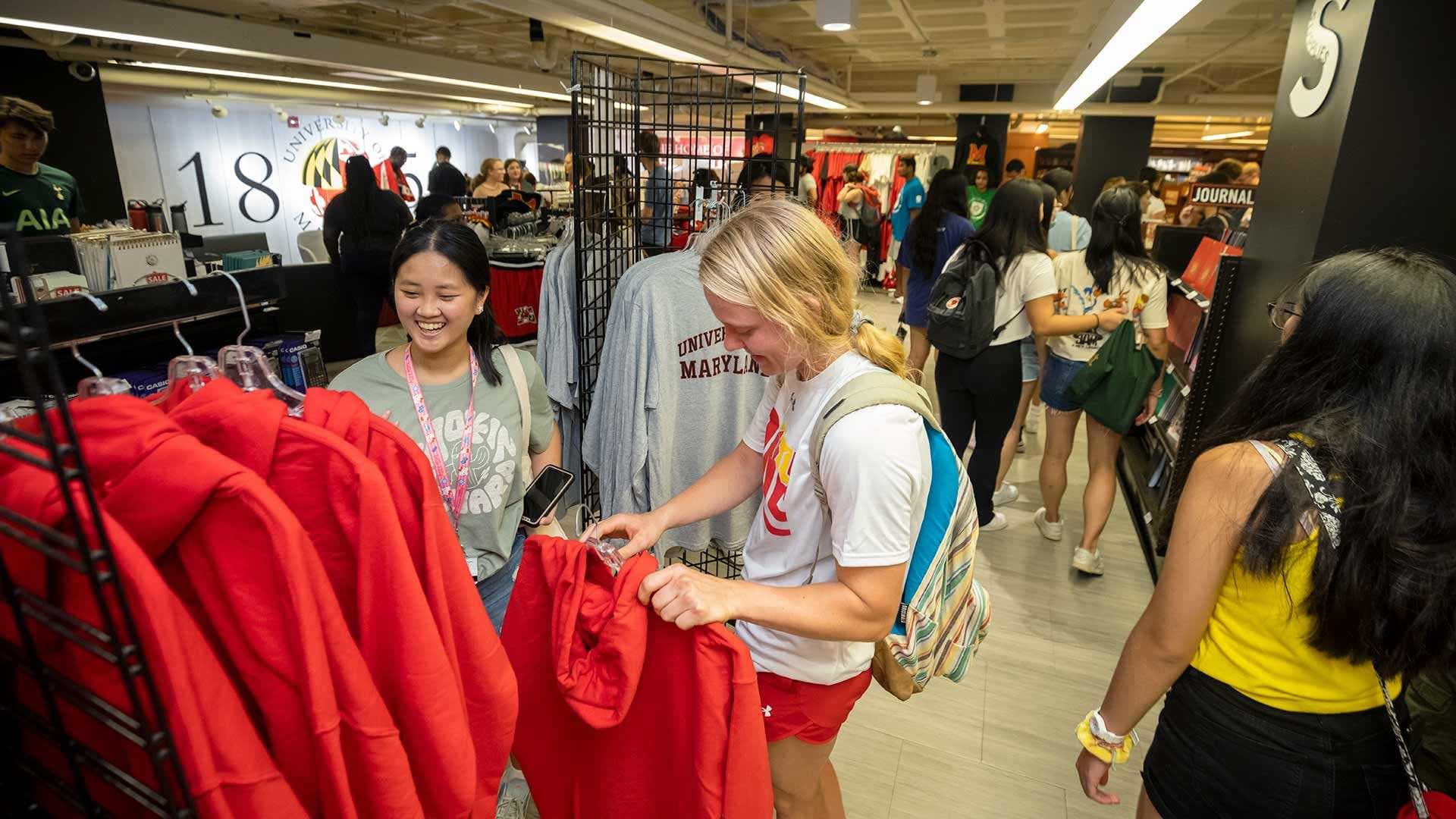students look at sweatshirts in bookstore