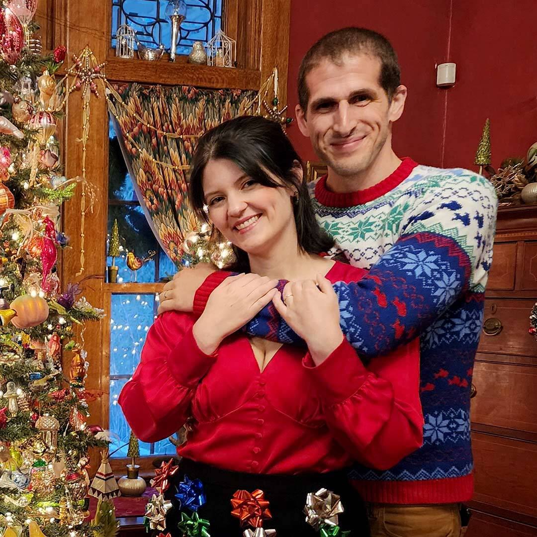 Emily and Manuel Nunez pose by Christmas tree