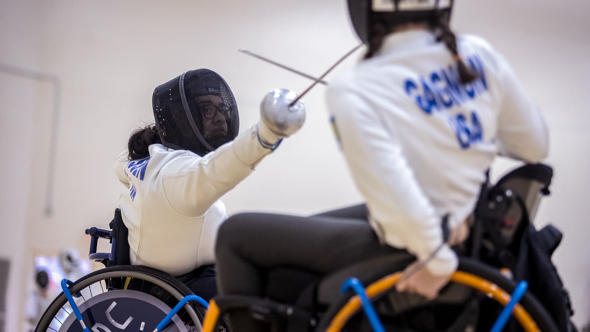 Two fencers in wheelchairs fence