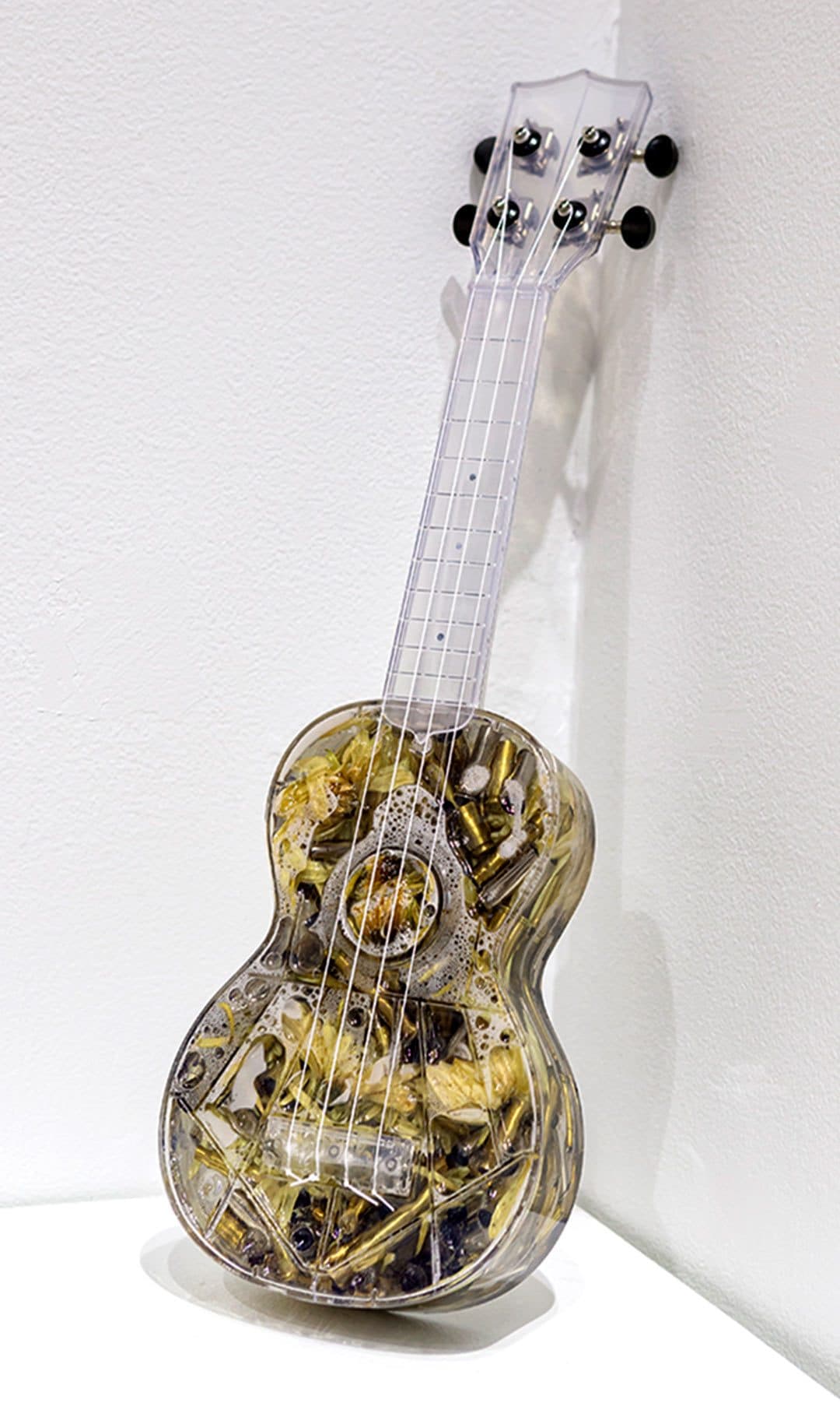 ukulele filled with shell casings and flowers