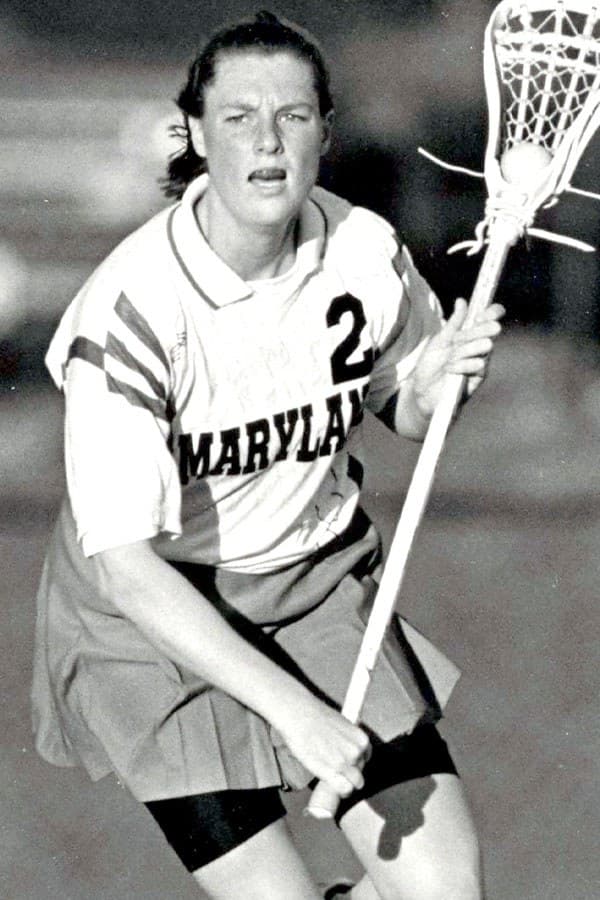 Black and white photo of female lacrosse player holding a stick