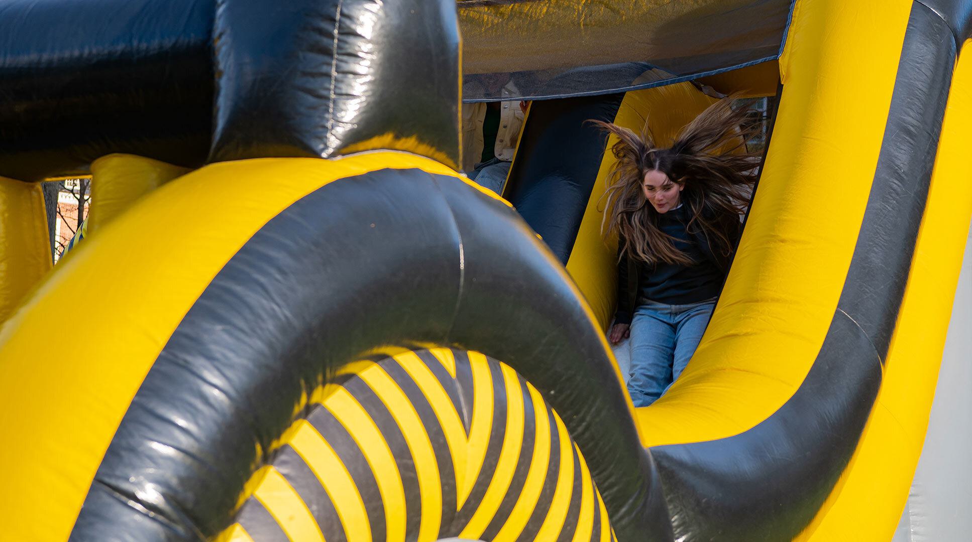person slides down inflatable slide