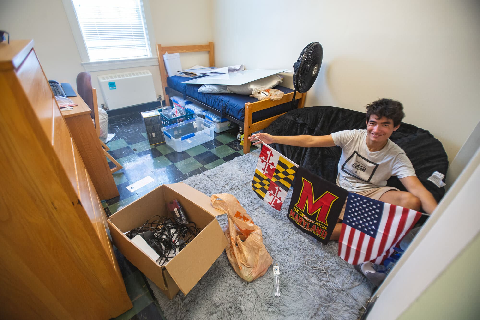 Student prepares to decorate his single room in Caroline Hall