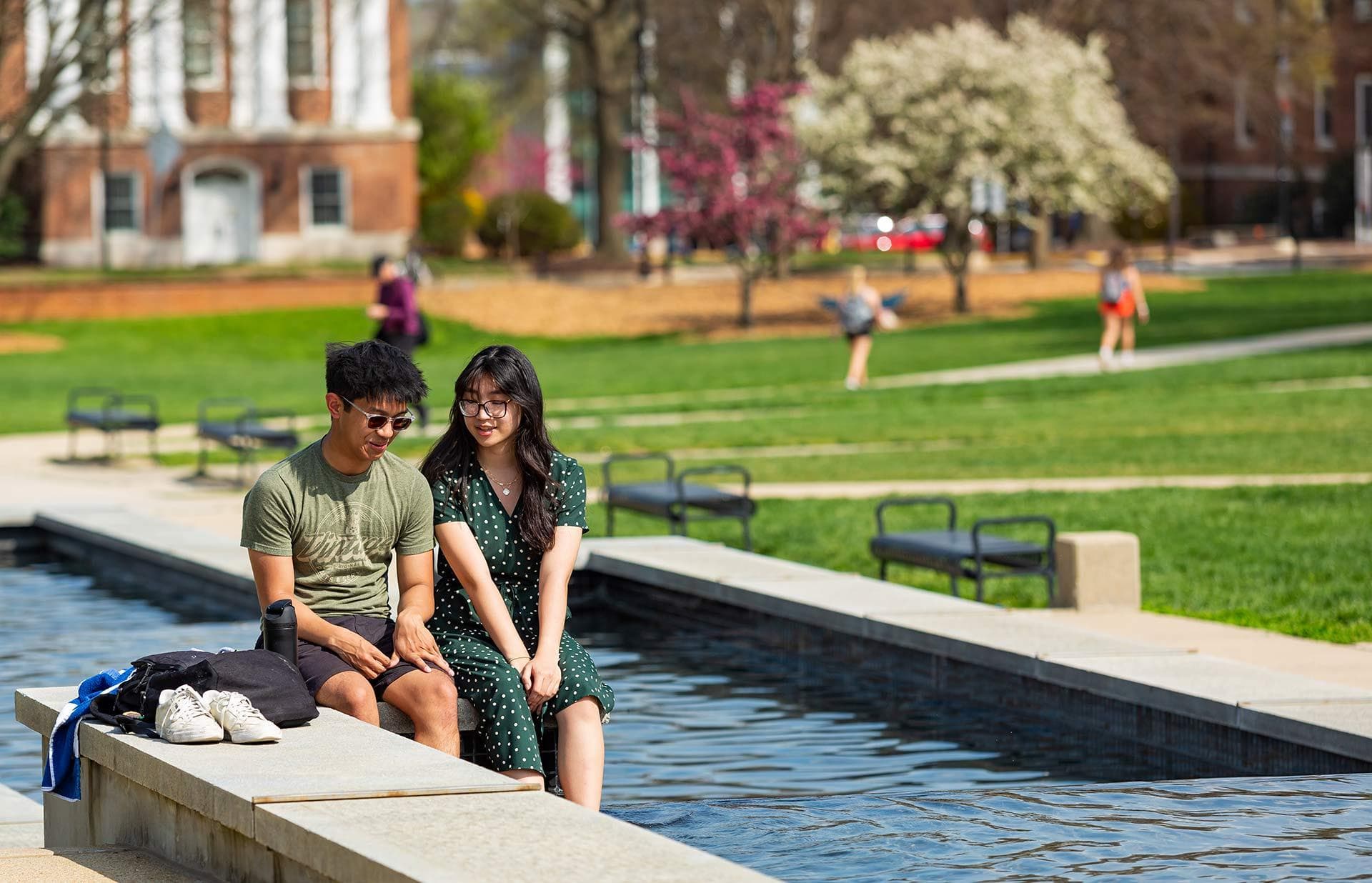 two students sit on edge of ODK Fountain