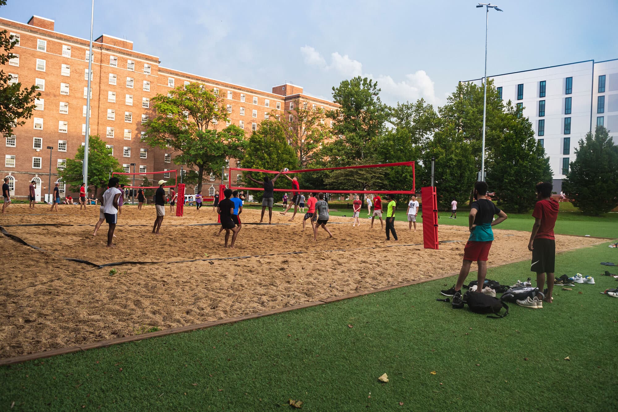 Students play volleyball outdoors