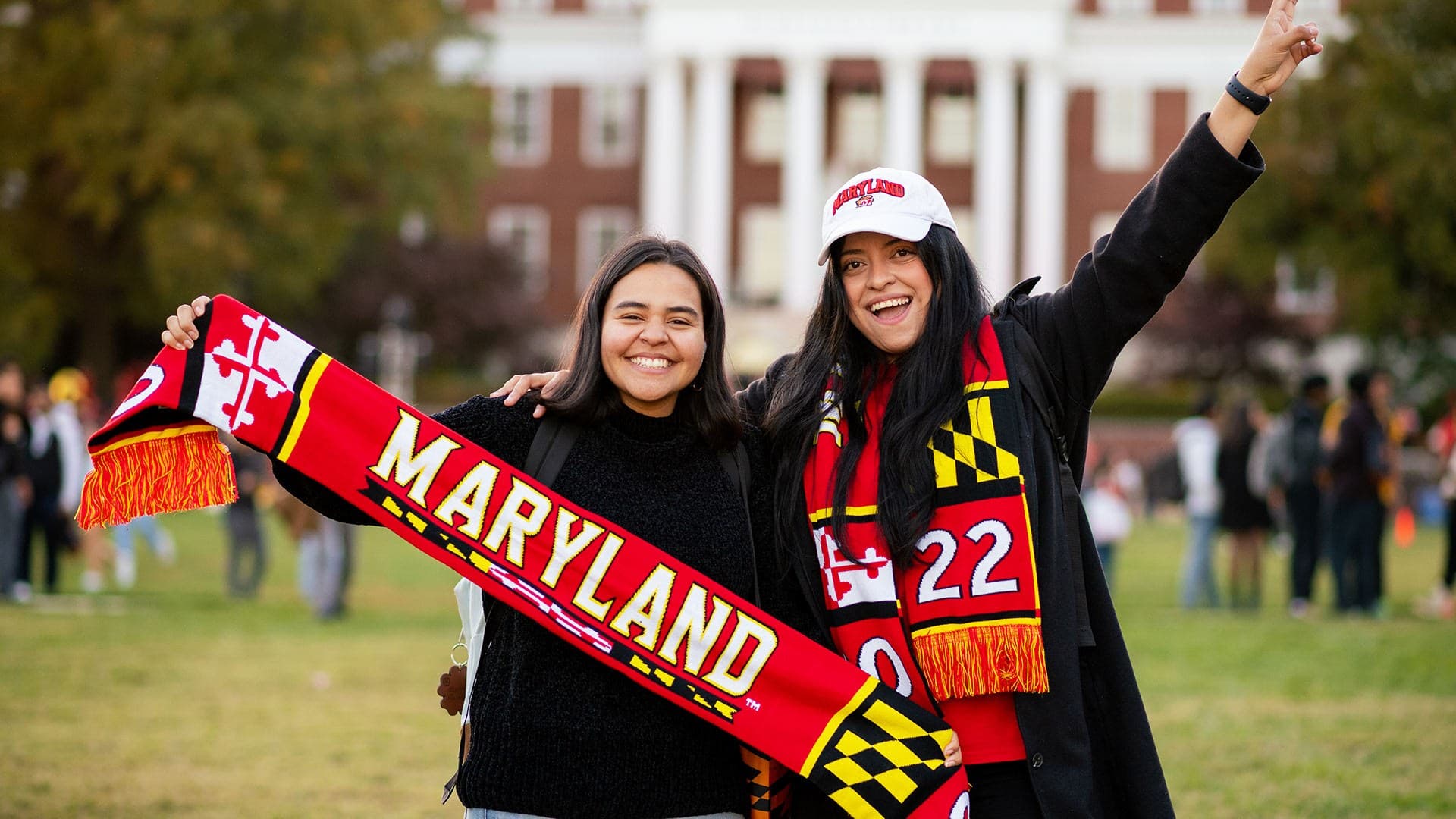 Students hold Maryland Banner at Terp Carnival