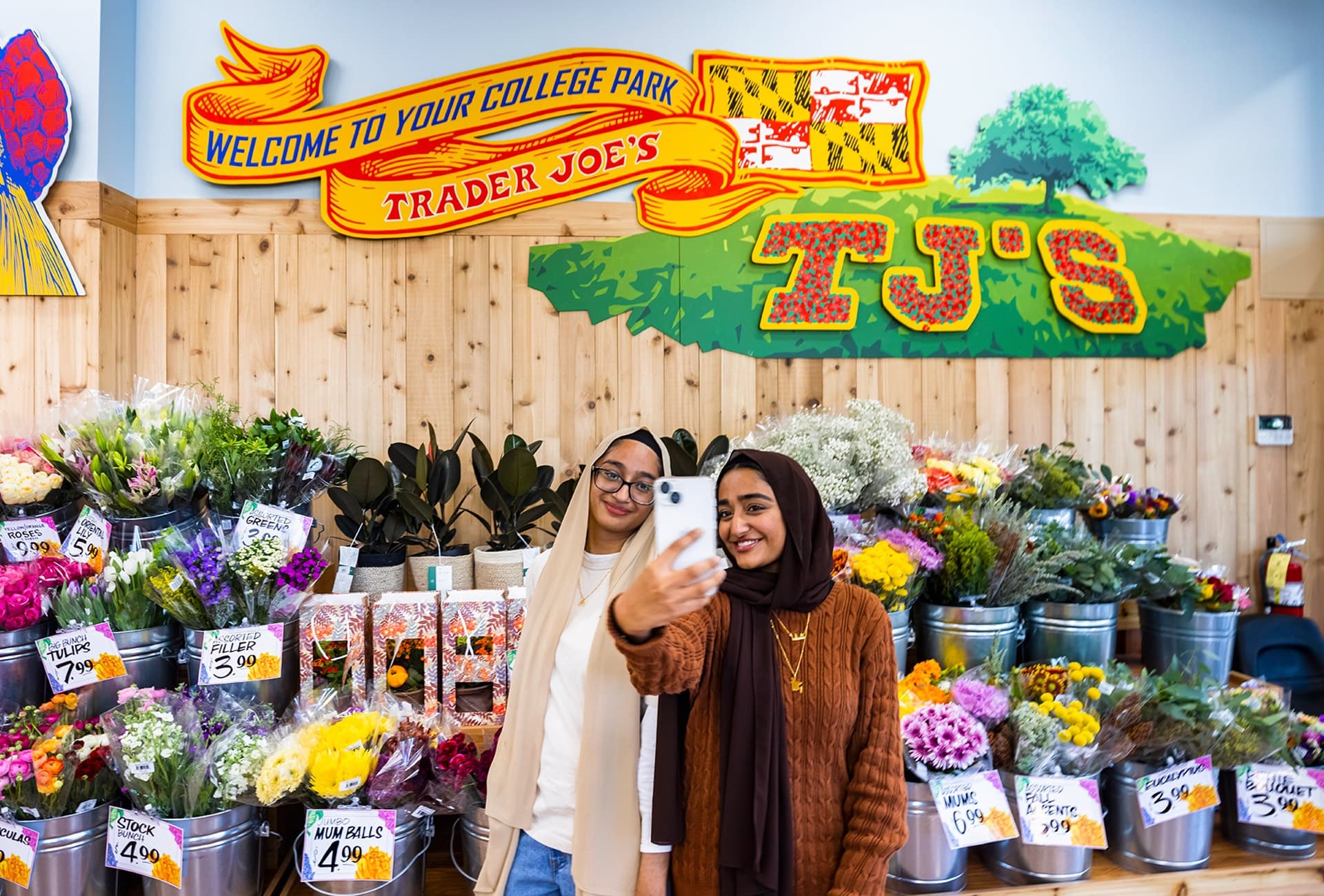 students take a selfie in the College Park Trader Joe's
