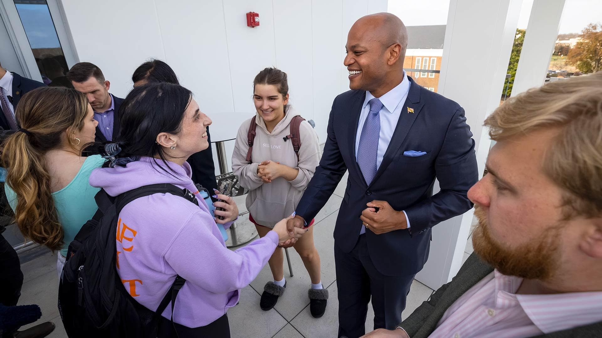 Wes Moore shakes hand with student