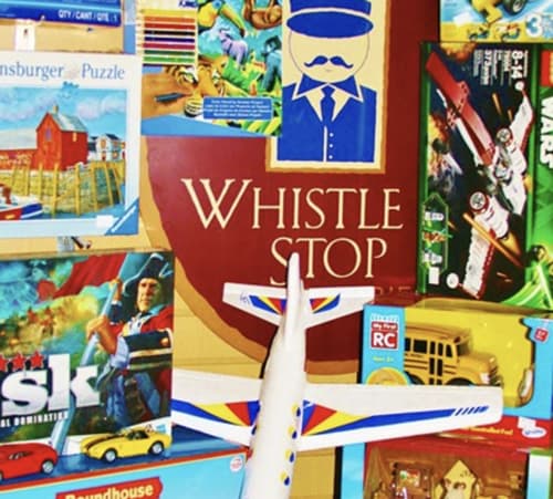 whistle stop logo with puzzles and planes