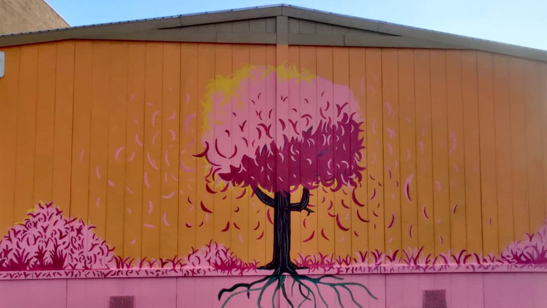 Pink tree mural on orange background