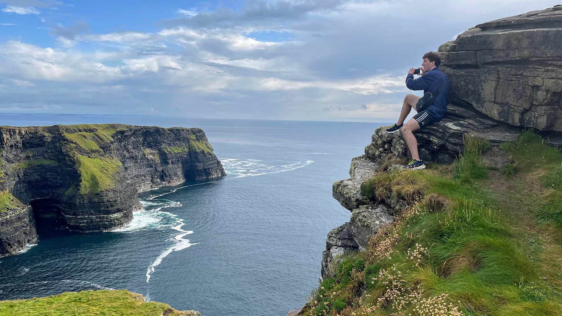 student views Cliffs of Moher
