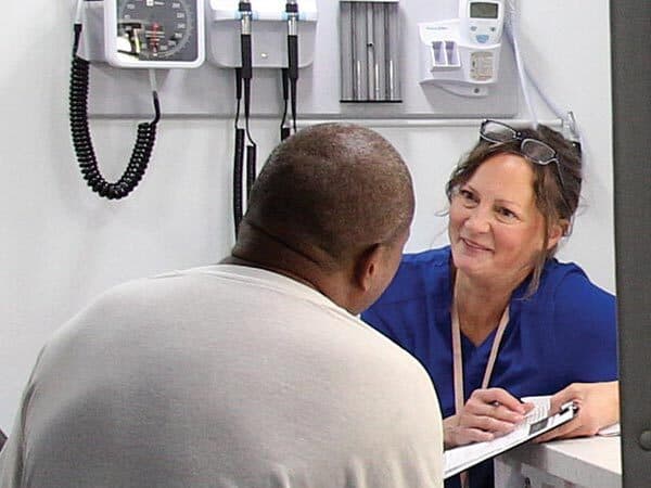 nurse speaks with patient