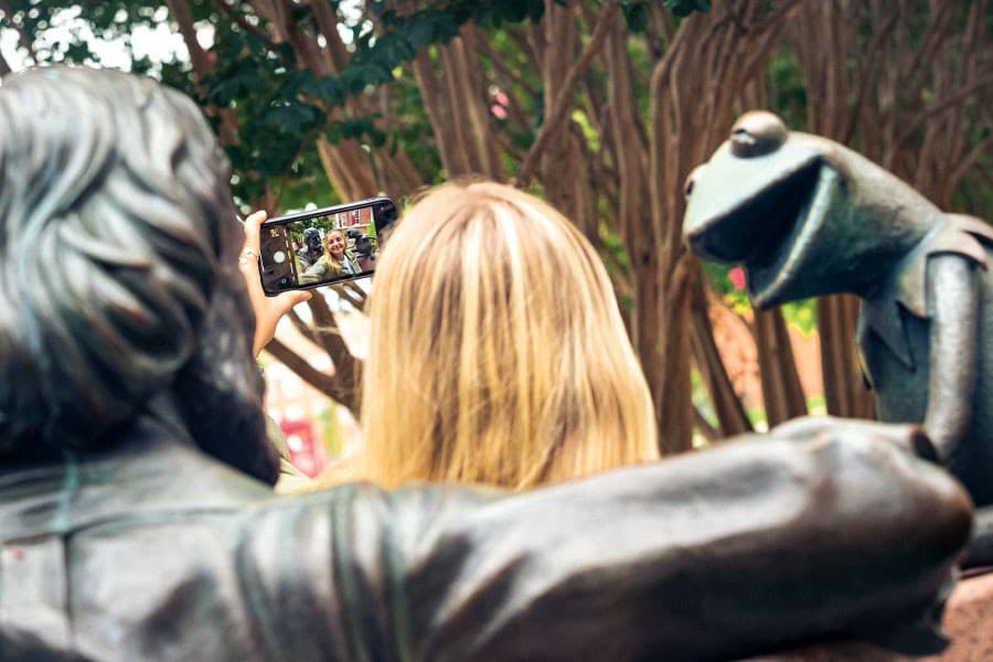 Student takes selfie with Jim Henson statue