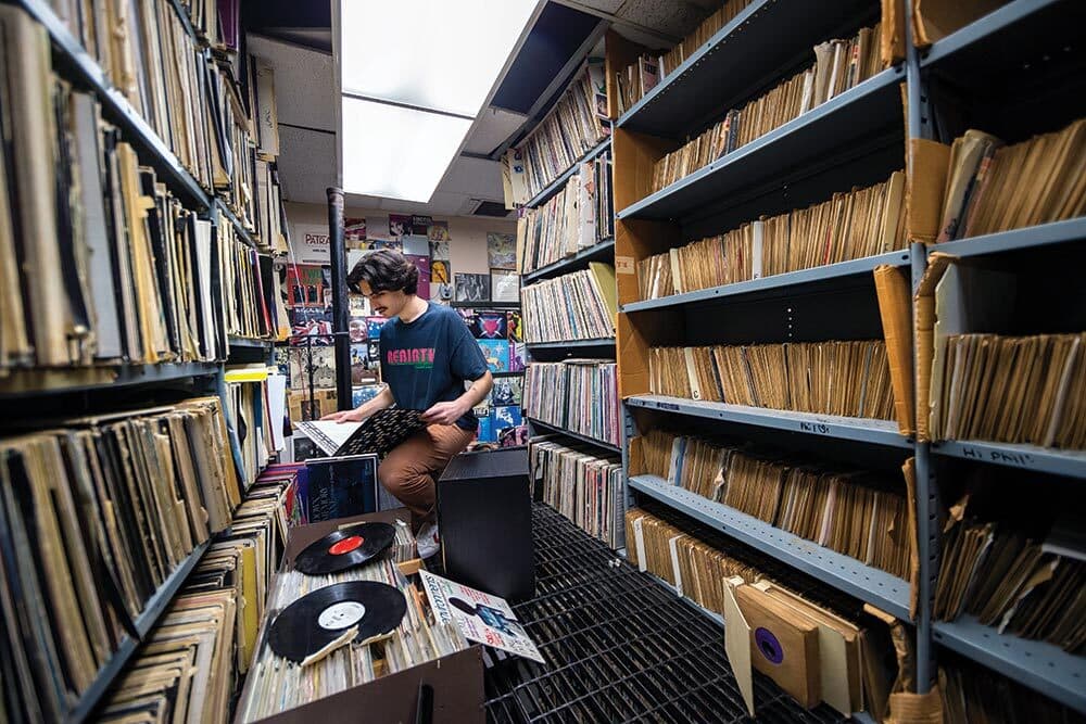 student organizes records in Record Library
