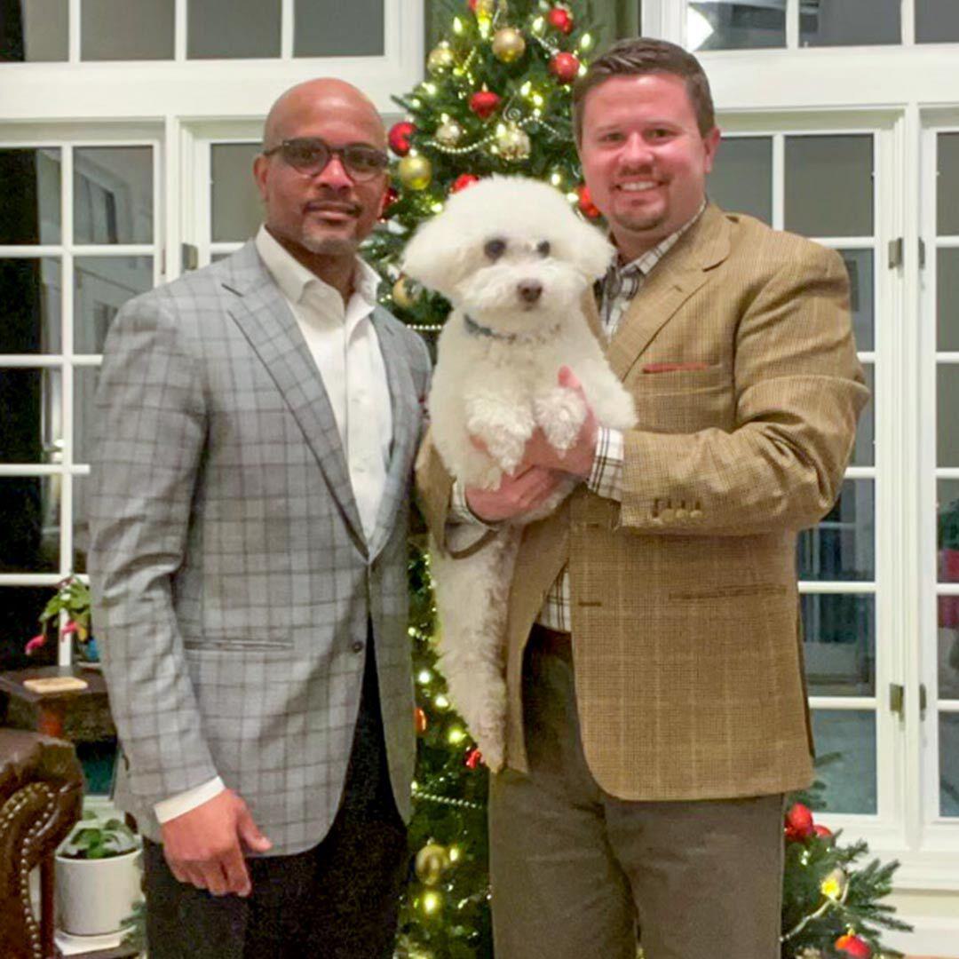 Tanner Kilpatrick and Patrick Williams with dog in front of Christmas tree