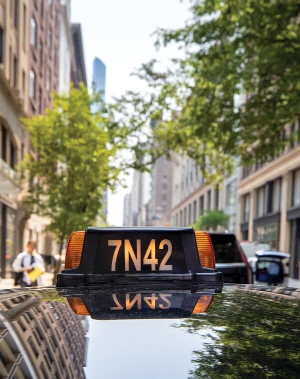 lighted letters and numbers on top of a taxi