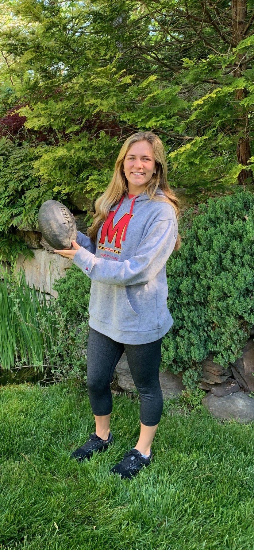 Kelly holds a football given to Reuben by his classmate and later university President Harry Clifton “Curley” Byrd.